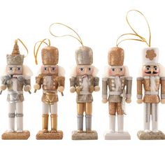 four nutcrackers are lined up against a white background