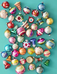 an assortment of glass ornaments on a blue background