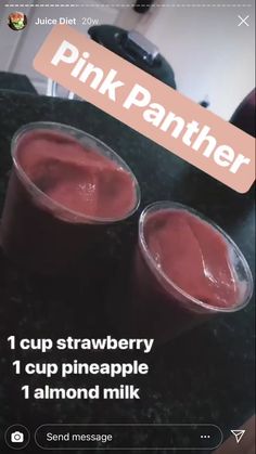 two plastic cups filled with liquid sitting on top of a table