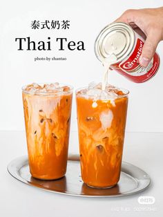 a person pouring tea into two glasses on top of a metal tray with the words, thai tea