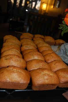 there are many muffins lined up on the table and one has a flower in it