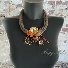 Whether you're looking for a unique gift for her or a handcrafted accessory to elevate your own style, this Handmade Necklace with Rustic Charm is the perfect choice. The necklace features a base crafted from quality khaki green cotton rope, elegantly adorned with a linen crochet applique in a harmonious blend of orange, brown, camel, green tones. The meticulous craftsmanship and thoughtful color combination make it a unique and charming accessory. Materials: quantity cotton blend rope, pure lin Handmade Bohemian Jewelry As Gift, Handmade Bohemian Jewelry For Gift, Handmade Bohemian Jewelry Gift, Unique Adjustable Beaded Pendant Necklace, Unique Adjustable Pendant Beaded Necklaces, Unique Adjustable Pendant Beaded Necklace, Handmade Bohemian Beaded Necklaces As Gift, Handmade Orange Beaded Necklaces As Gift, Handmade Adjustable Orange Necklace