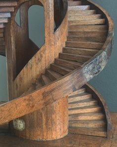 an old wooden spiral staircase in a home