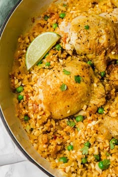 chicken and rice in a skillet with a lime wedge