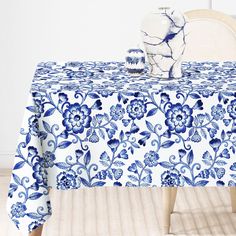 a blue and white table cloth with flowers on it