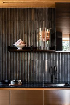 a modern kitchen with stainless steel backsplash and wood paneling on the wall