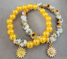 Two sunflowers 10MM Agate beads bracelets with charms Sunflower Clay Bead Bracelet, Unique Yellow Beaded Bracelets With Round Beads, Handmade Yellow Round Beaded Bracelets, Yellow Beaded Round Bracelets, Sunflower Beaded Bracelet, Black Buddha, Acrylic Nails Almond Shape, Rhinestone Sunglasses, Buddha Necklace