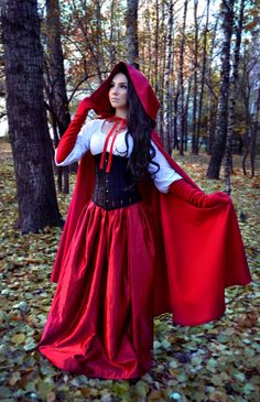 a woman dressed as a red riding hood and cape