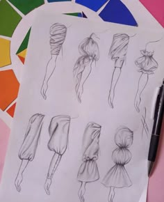 a drawing of different hair styles on top of a piece of paper with a pen