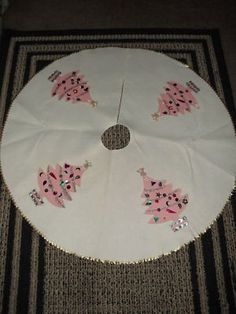 a white table cloth with pink pigs on it and silver sequins around the edges