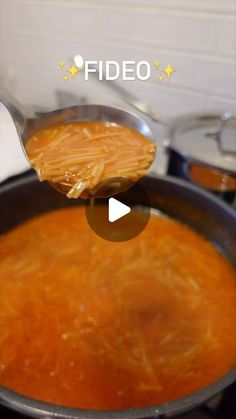 a ladle full of food is being held by a person with a spoon in it