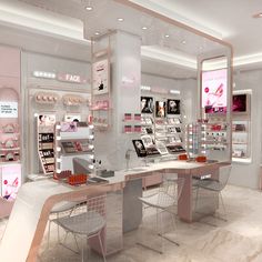 the interior of a cosmetics store with pink and white accessories on display in front of it