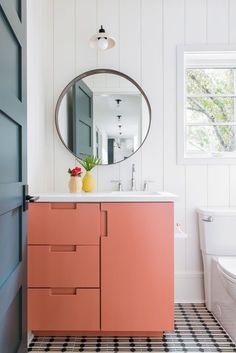 a bathroom with a sink, mirror and toilet