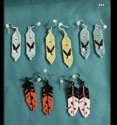 six pairs of beaded earrings on a blue background