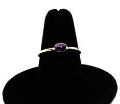 ** SOLID 14K OR 10k SOLID GOLD 5x3mm OVAL NATURAL AMETHYST CABOCHON RING ** 1.3 mm Solid 14k or 10k lightly hammered gold band. Use the pull down tab for your personal selection. All my rings are Hand forged with Solid 14k or Solid 10k Gold Oval Setting and band. Oval Cabochon Cut 5x3mm Natural AA Amethyst gemstone. Amethyst has a deep Purple color in the stone. Amethyst is February Birthstone.  Perfect ring to wear for casual or formal events.   A lovely gift for your special someone or for you Oval Amethyst Ring, Gemstone Stacking Ring, August Birthstone Ring, March Birthstone Ring, Oval Setting, November Birthstone Ring, Gold Amethyst Ring, Deep Purple Color, London Blue Topaz Ring