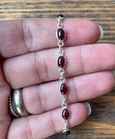 Lovely dainty garnet silver bracelet. The stones are made from natural garnet,  a beautiful red stone. Perfect  to wear on its own or layering with your favourite bracelets.  13 oval crystals link together  21 cm long adjust to 20 cm   0.5 cm width Gift box available for purchase. Buy multiple items and only pay for one shipping cost. 🛍️ Subscribe to our email list for exclusive discounts and GET 20% OFF your next order in our Etsy Shop! Copy and paste this link into your browser to join: https://bit.ly/3BzMfDB Bracelet For Her, Bracelet Christmas, Bracelet Minimalist, Garnet Bracelet, Dainty Bracelet, Dope Jewelry, Funky Jewelry, Minimalist Bracelet, Jewelry Lookbook