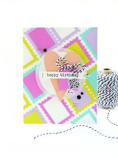 a birthday card with a spool of thread next to it