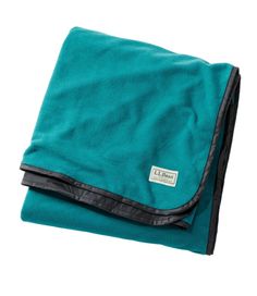 the teal and black blanket is folded up