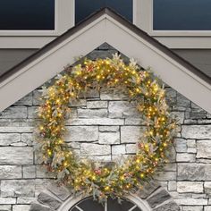 a wreath is hanging on the side of a house