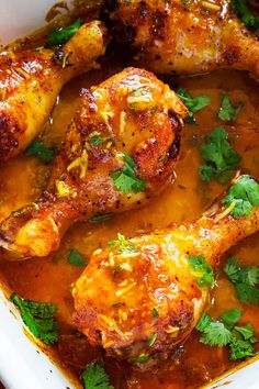 chicken legs covered in sauce and garnished with parsley