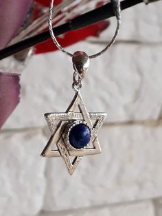 Jewish symbol of protection and balance. Sterling Silver Magen David necklace. Unisex necklace. Great gift for birthday, bar mitzvah, or holiday gift. Feature sterling silver Magen David handmade texture, Lapis Lazuli set in the center of the star. A silver chain connects to the Silver Star. Magen David size: 1.2\0.7 inch Gemstone size: 6mm. Length to order: 16-30 inches. Choose silver chain: wheat or foxtail. 🔸 All my creations made by me from Fine Materials, Gemstones, high quality. 🔸 Unique Silver Star Of David Necklace With Gemstone, Silver Star Of David Necklace For Hanukkah, Magen David Necklace, Handmade Texture, Jewish Symbol, Sterling Silver Gemstone Necklace, Silver Star Necklace, Judaica Jewelry, Birthday Bar