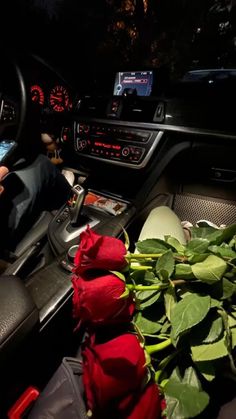 a person sitting in the driver's seat of a car holding a cell phone