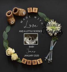 a baby announcement with flowers and shoes