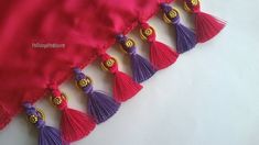 red and purple tassels are hanging from the side of a pink dress with gold accents