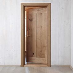 an open wooden door in a white room