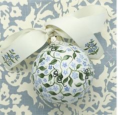 a blue and white ornament with flowers on it