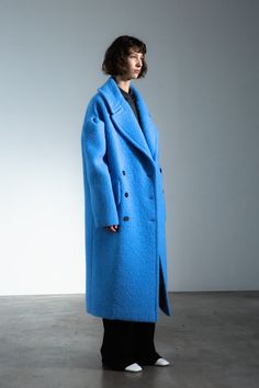 Drop-shoulder coat, virgin wool, sky blue. Crafted in soft alpaca and luxe virgin wool, this sky blue statement coat epitomizes femininity imbued with playfulness. Accented by pleated dropped-shoulders, it creates a fierce, unexpected silhouette. Blue Wool Long Coat, Chic Blue Wool Coat For Fall, Chic Blue Wool Coat, Chic Blue Wool Coat For Winter, Chic Blue Wool Outerwear, Drop Shoulder Coat, Lagoona Blue, Blue Crafts, Statement Coat