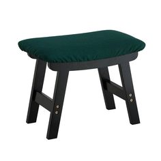 a small stool with a green cushion on it