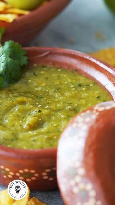 a bowl filled with guacamole surrounded by chips