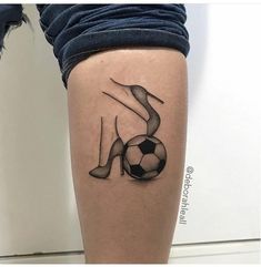 a woman's leg with a soccer ball tattoo on her right thigh and legs