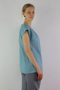 "Handmade turquoise linen blouse with short sleeves, perfect for casual wear and suitable for any occasion in any season Details: - 100% natural linen produced in Europe ; - medium weight (180 gram per square meter); - color: turquoise, can be any from our colors catalog (color samples at the photo); Made to order, approximately a few days, If you have any questions please message me and I will be glad to answer. Size guide : Size XS Bust: fits bust around 33\"-34\"/ 84-88 cm Waist: fits waist a Blue Linen V-neck Blouse, Light Blue Relaxed Fit Linen Tops, Relaxed Fit Light Blue Linen Tops, Casual Turquoise Short Sleeve Blouse, Light Blue Linen Short Sleeve Top, Turquoise Short Sleeve Top For Summer, Turquoise Relaxed Fit Short Sleeve Top, Turquoise Short Sleeve Top With Relaxed Fit, Turquoise Short Sleeve Top Relaxed Fit