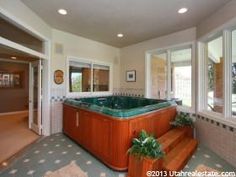 a large jacuzzi tub sitting in the middle of a living room