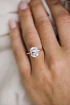 a woman's hand with a diamond ring on it