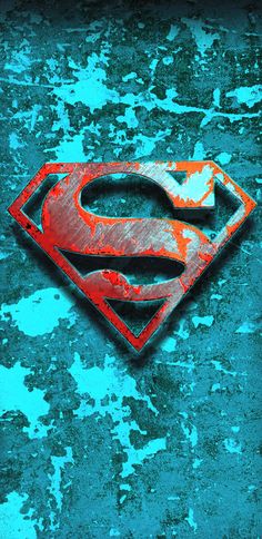 a superman logo painted on the side of a building in blue and orange paint with rusted edges