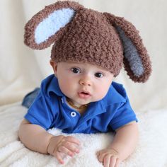 a baby wearing a knitted hat with ears