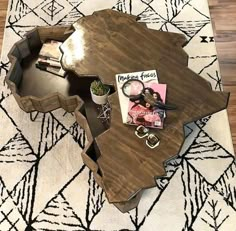 a coffee table with magazines and other items on it in the middle of a room