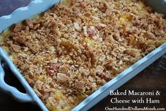 baked macaroni and cheese with ham in a blue dish on a wooden table