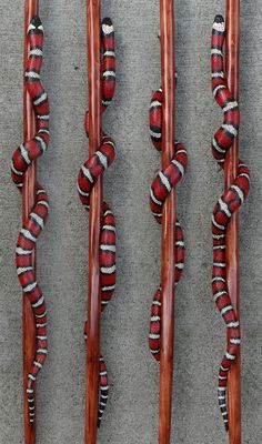 four wooden skis lined up on top of each other with strings attached to them