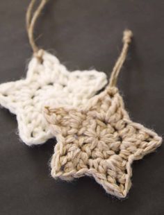 a crocheted star ornament hanging from a string on top of a table