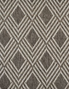 an upholstered fabric pattern with diamond shapes in brown and white colors, closeup