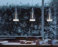 a table with three lights hanging over it