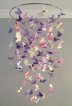 a mobile made out of paper butterflies hanging from the ceiling