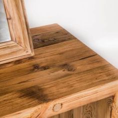 a mirror sitting on top of a wooden table