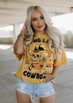 Long Live Cowboys Skull OVERSIZED 80's throwback distressed Cropped T- shirt available in faded mustard This Crop Jersey Tee slides right into streetwear style for Summer and Winter.. With oversized sleeves and a relaxed body, this on-trend tee drops a little lower in the back for an effortlessly cool feel. Fabricated from ultra-soft, lightweight Airlume cotton that's fit to flatter, this looser crop features a finished hem and neck binding.Features: Finished hem. Oversized sleeves. Neck binding Acid Wash T-shirt For Fall Streetwear, Oversized Hip Hop Tops For Halloween, Trendy Acid Wash Tops For Fall, Yellow Hip Hop Short Sleeve Tops, Yellow Short Sleeve Hip Hop Top, Trendy Acid Wash T-shirt For Fall, Oversized Acid Wash T-shirt For Fall, Distressed Edgy Tops For Fall, Edgy Cropped T-shirt For Spring Streetwear