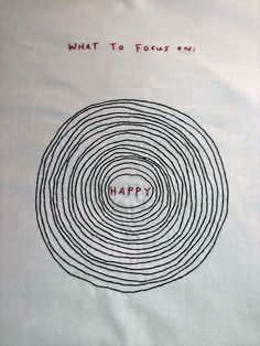 a piece of cloth with the words happy written in red on it and an image of a spiral