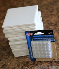 a stack of white paper sitting on top of a counter next to a pack of erasers